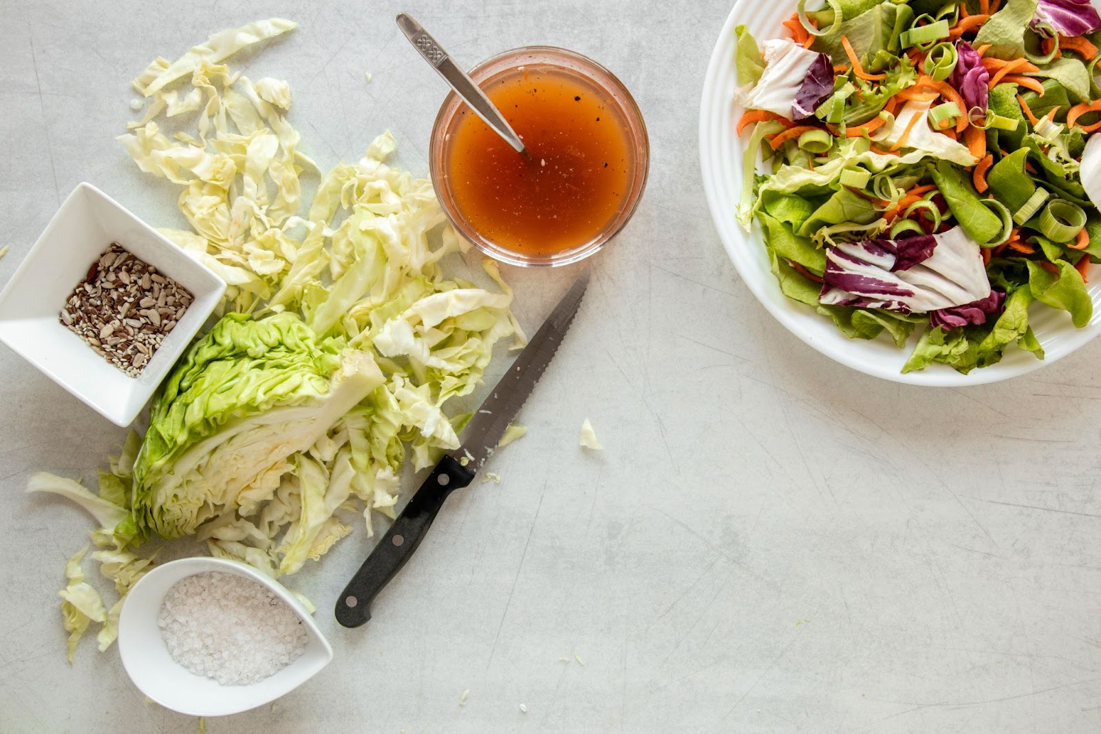 Top view of fresh cabbage and dressing for salad