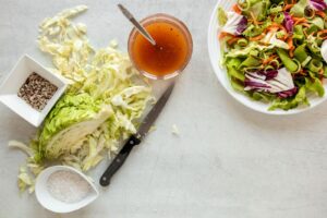 Top view of fresh cabbage and dressing for salad
