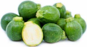 Lots of little green pumpkins lying in a pile