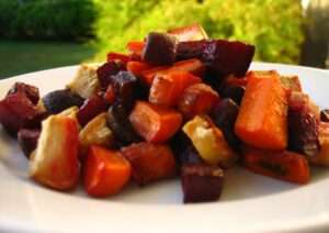 Roasted vegetables lie on a white plate